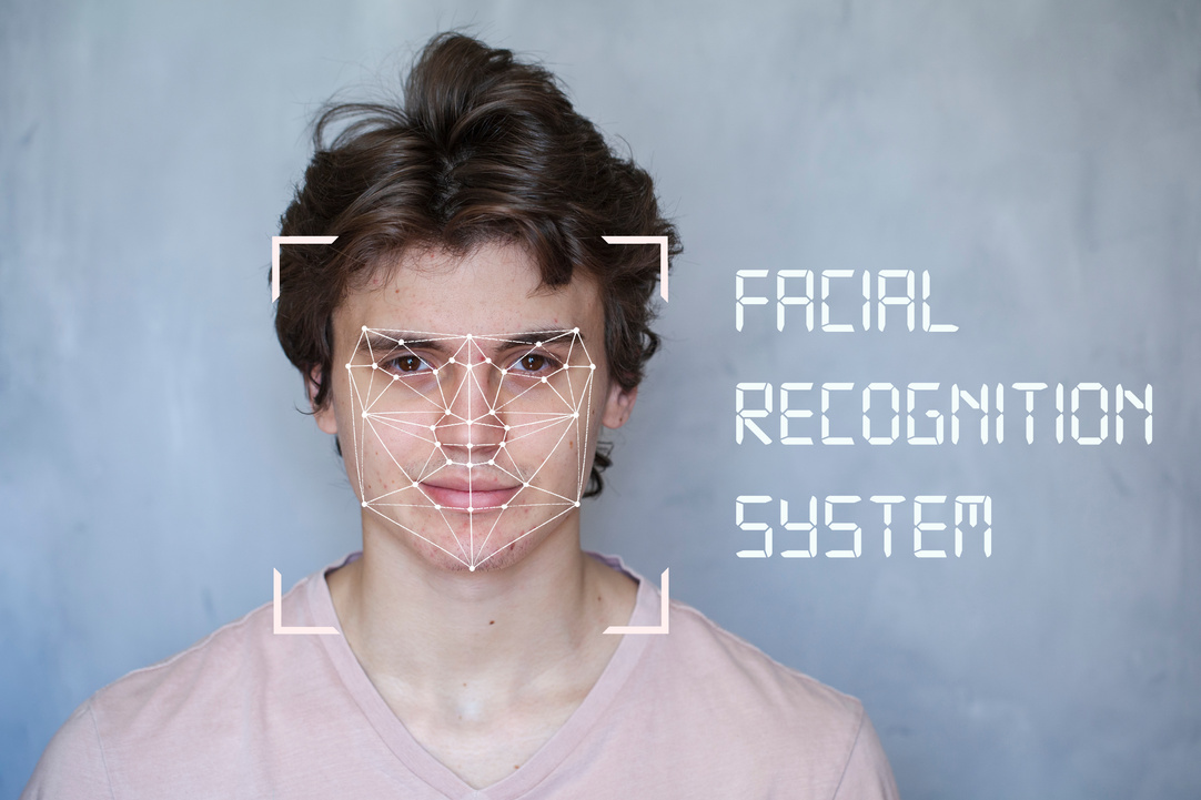 Human Security IT technology, Facial recognition system, concept. Young man on the gray background, face recognition